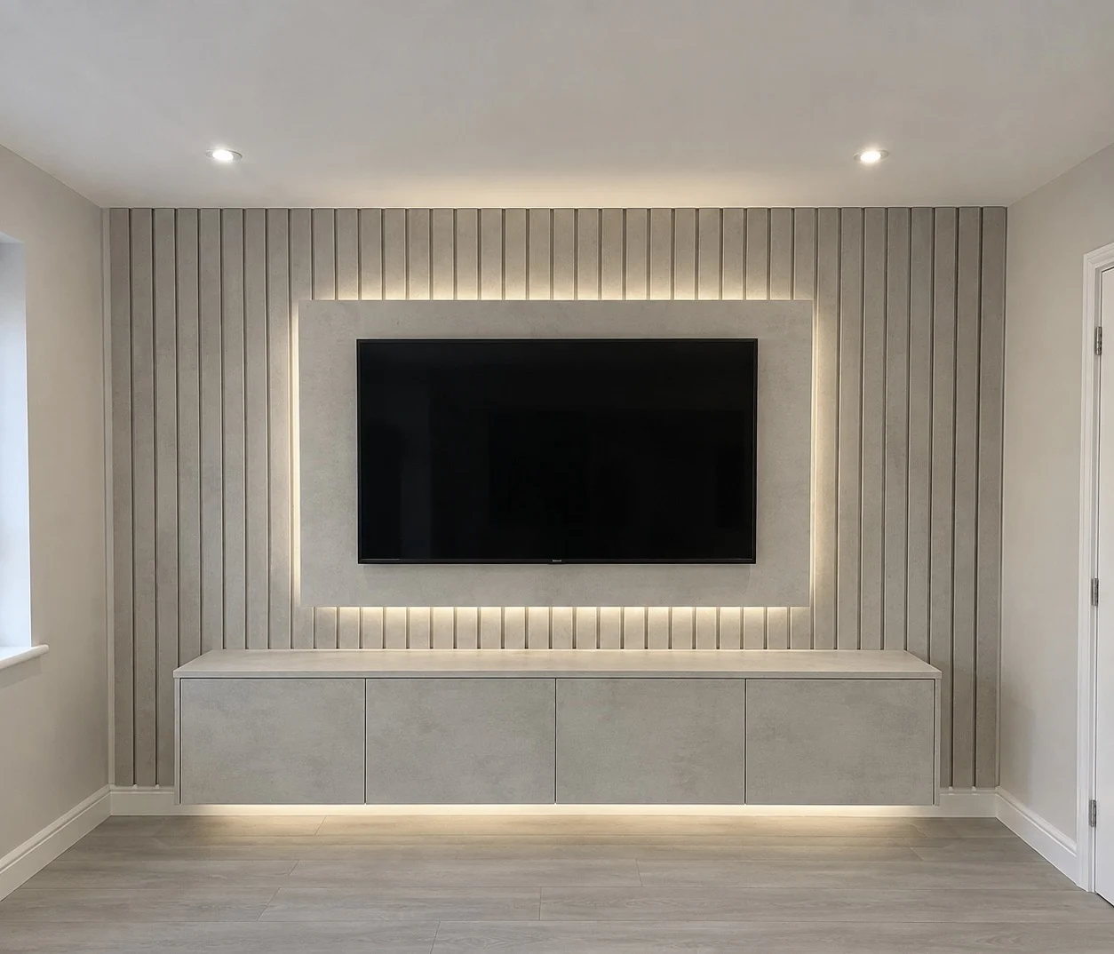Grey panelled media wall with a backlit TV surround and floating storage